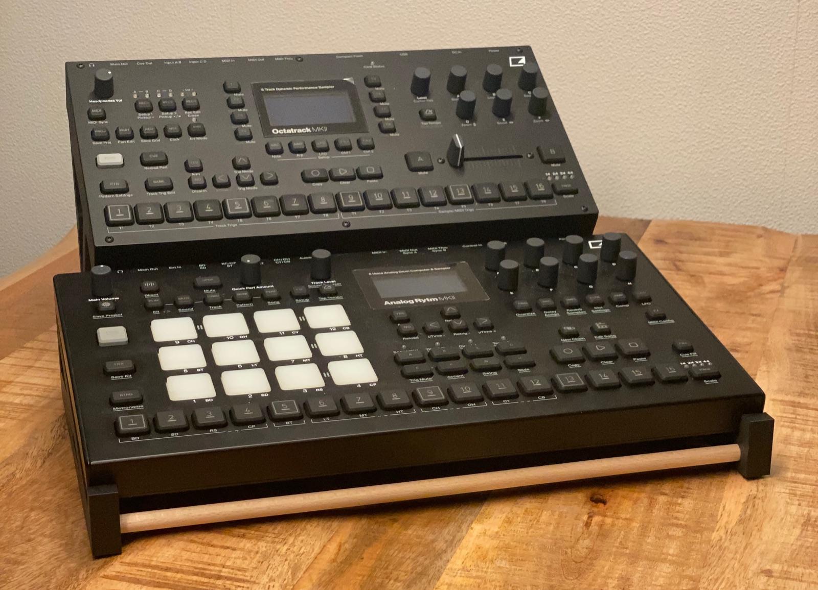 Elektron Analog Rytm MKII on a low stand, with an Octatrack MKII tiered on a taller stand behind it